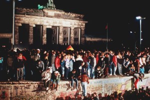 Cheering people stand on the Berlin Wall at Brandenburg Gate on Nov. 9, 1989.